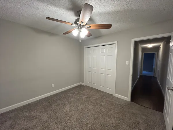 a view of an empty room with a fan