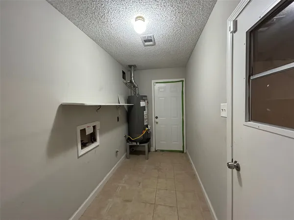 a view of a hallway with workspace and a window