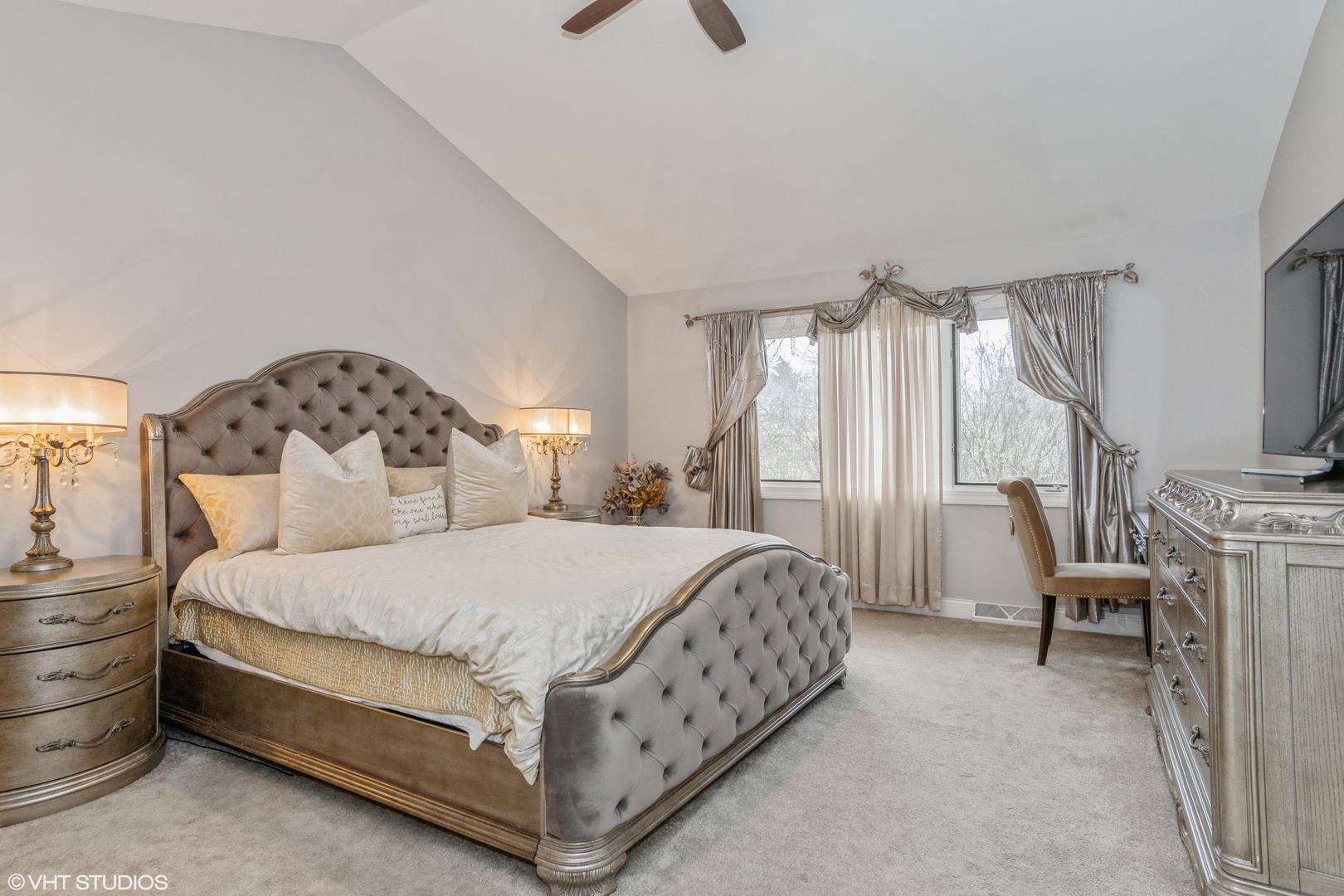 288 Windsor Drive Bartlett, IL 60103 - Photo 13 of 24 a bedroom with a bed a mirror on dresser and a chandelier