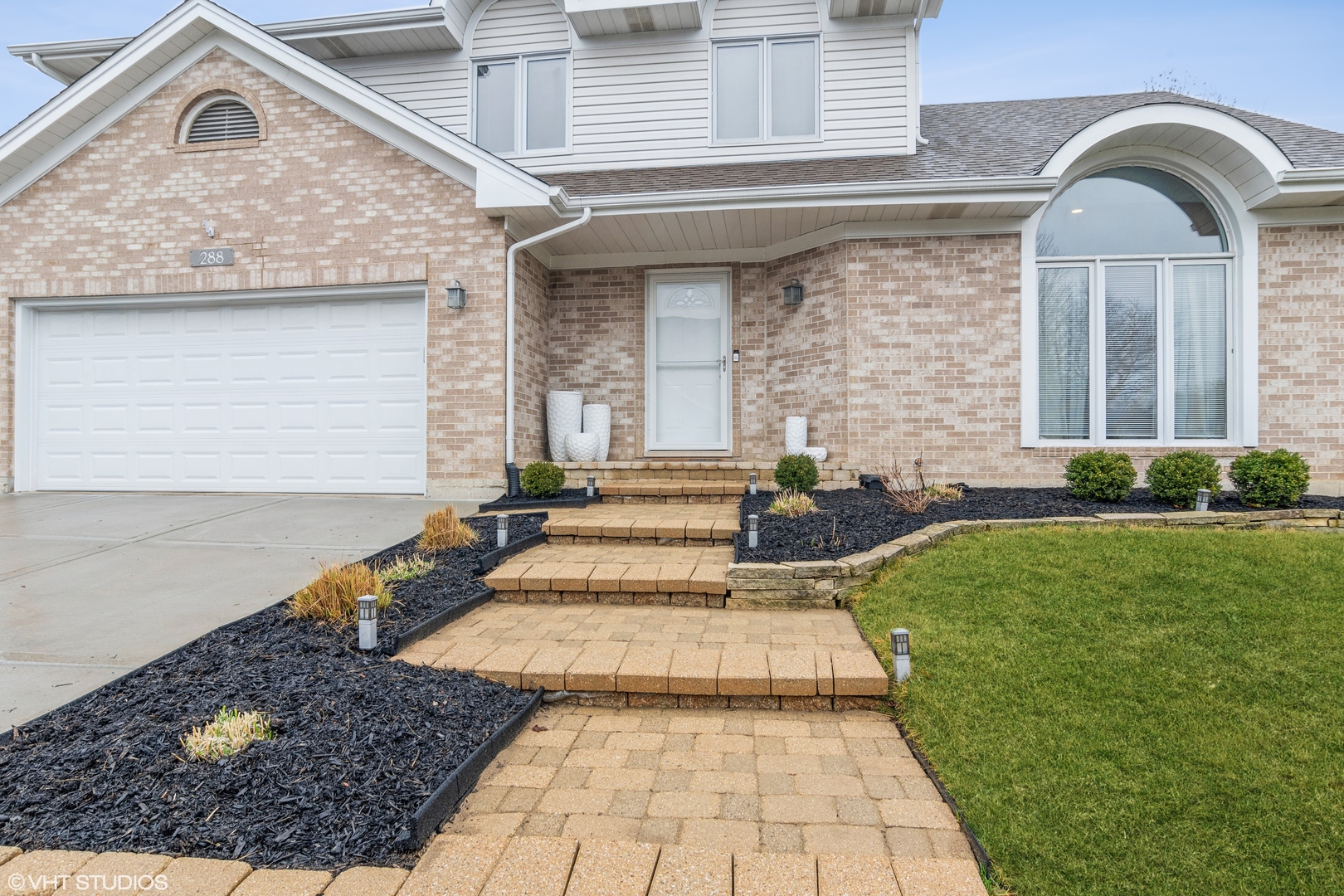 288 Windsor Drive Bartlett, IL 60103 - Photo 2 of 24 a front view of a house with garden