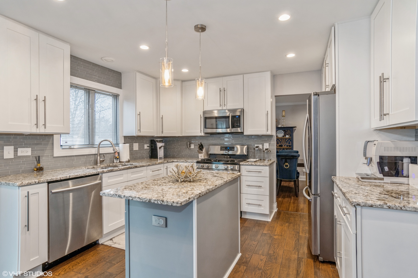 288 Windsor Drive Bartlett, IL 60103 - Photo 6 of 24 a kitchen with a sink stove a refrigerator and white cabinets