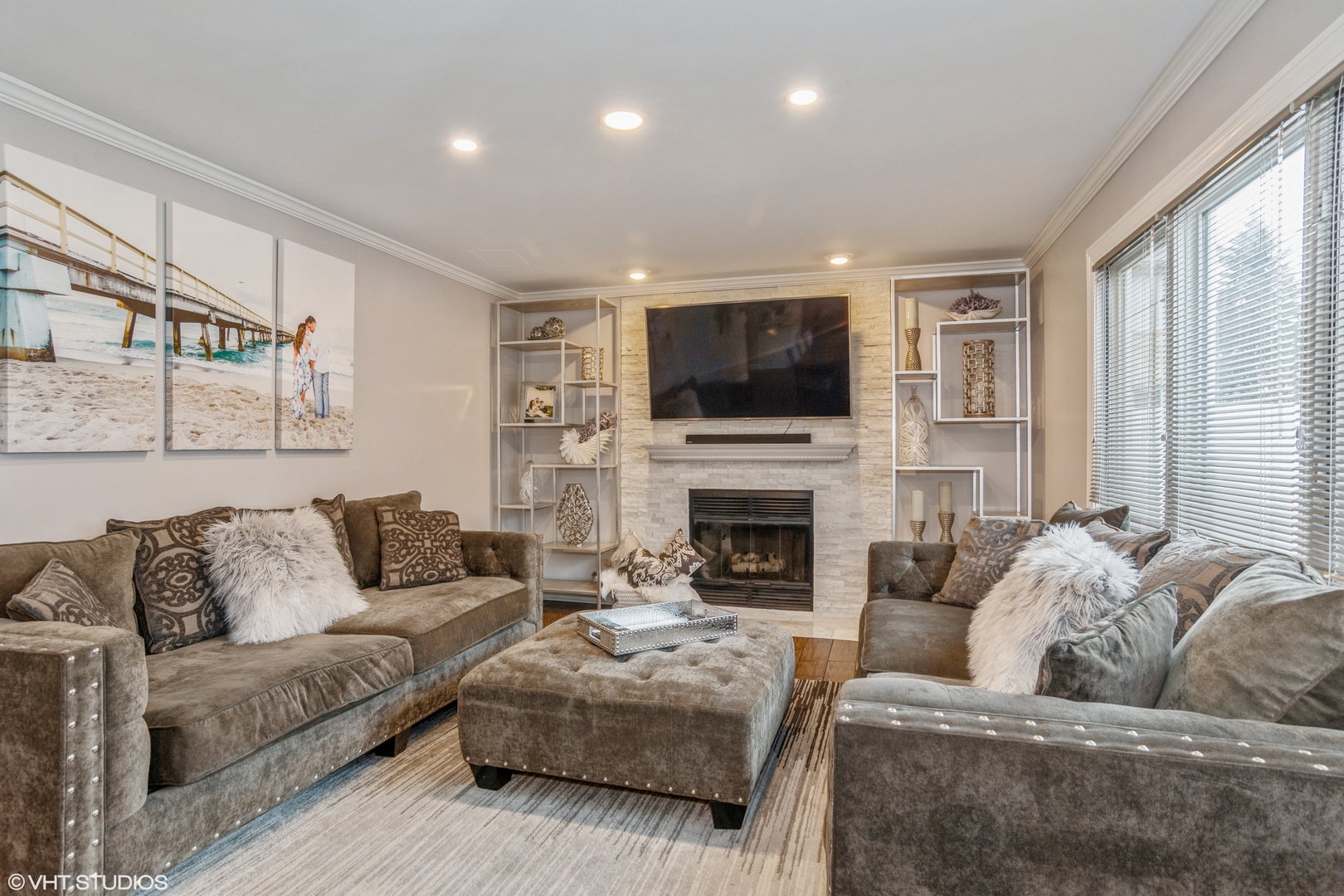 288 Windsor Drive Bartlett, IL 60103 - Photo 10 of 24 a living room with furniture a fireplace and a flat screen tv