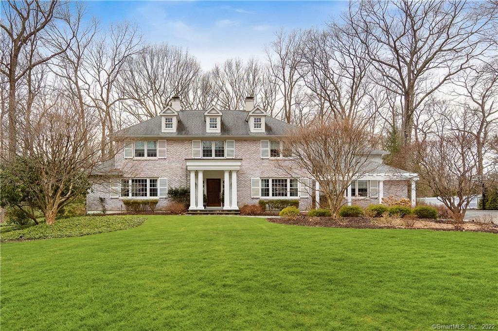 219 Bayberry Lane Westport, CT 06880 - Photo 1 of 1 a front view of a building with a garden
