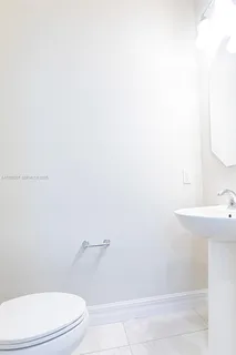 a white toilet sitting next to a white sink