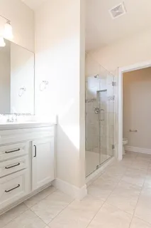 a bathroom with a shower sink and mirror