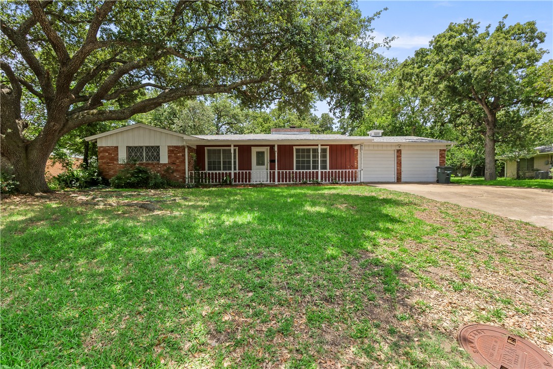 Ranch-style home with covered porch, board and bat