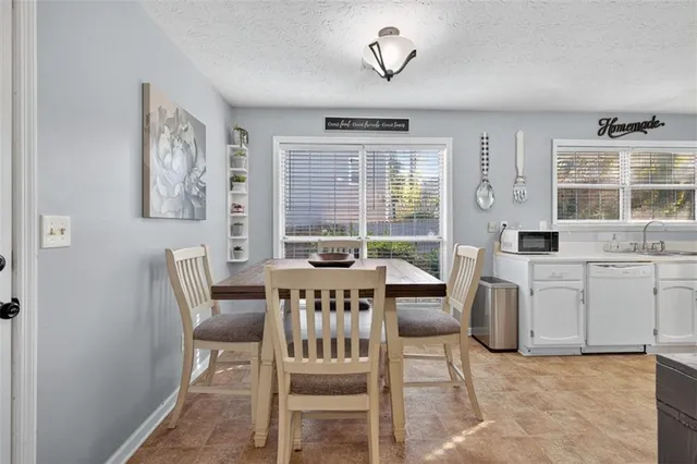 a view of a livingroom with furniture window and a kitchen
