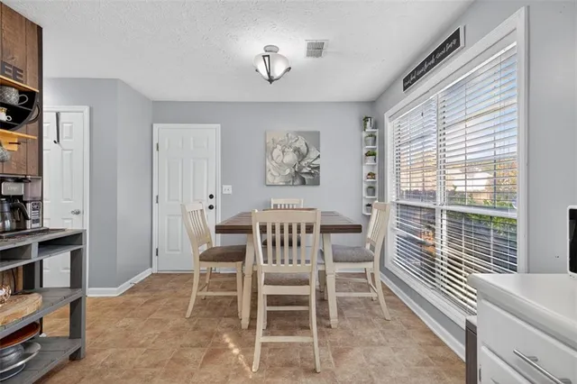 a dining room with furniture and window