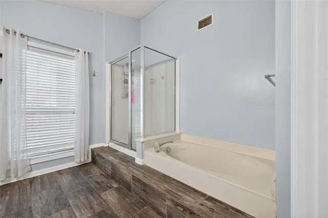 a bathroom with a bathtub and a shower