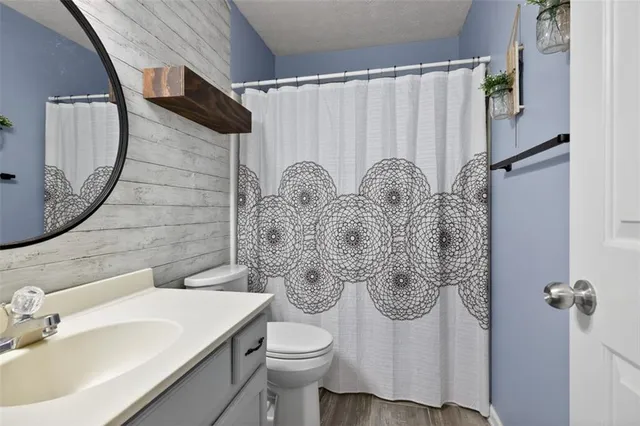 a bathroom with a sink toilet and shower