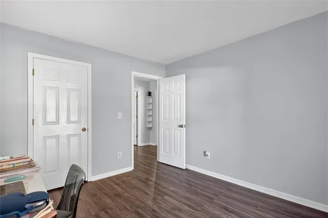 a view of a room with wooden floor closet and mirror