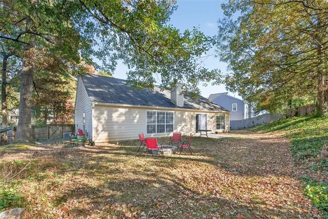a view of a house with a yard and tree s