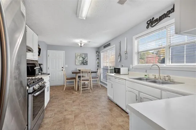 a kitchen with appliances cabinets and furniture