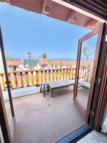 a view of chairs and bench in balcony