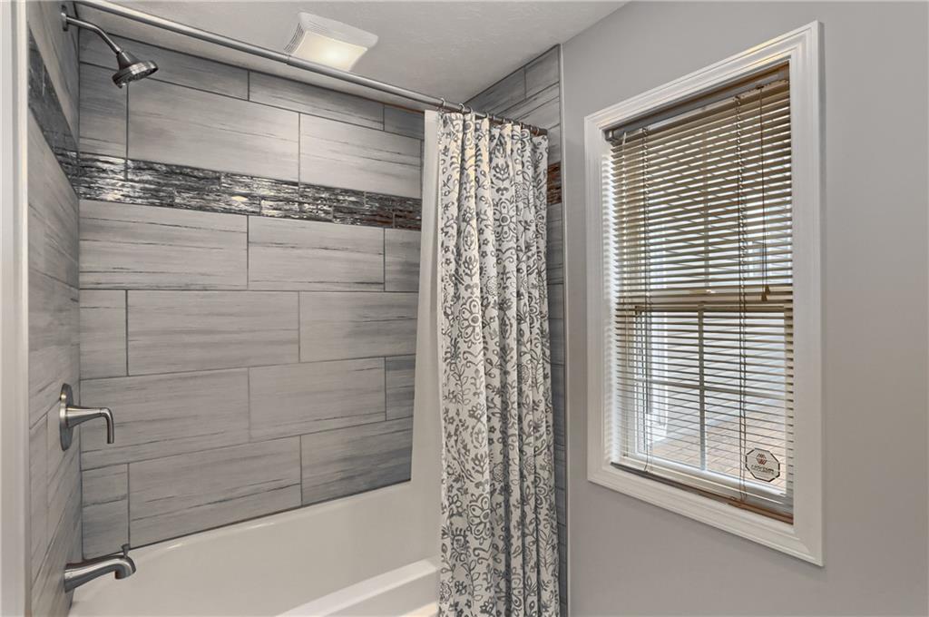 110 Oakville Road Beaver Falls, PA 15010 - Photo 30 of 48 Start and end your day in this tiled tub/shower combo with a stylish tile inlay.