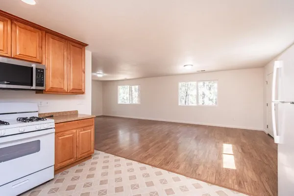 a kitchen with a stove a sink and a microwave