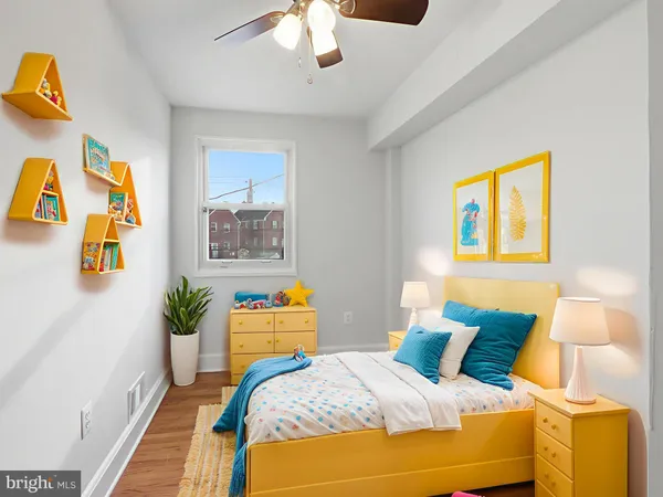 a bedroom with a bed and a potted plant