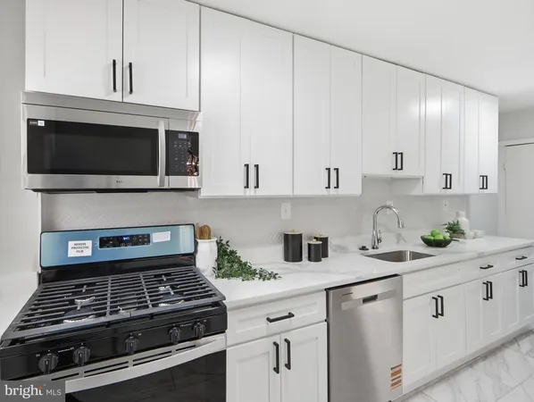 a kitchen with cabinets and appliances