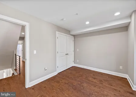 a view of walk in closet with empty racks
