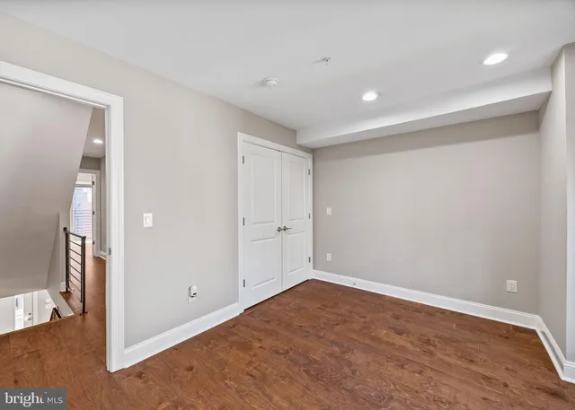 a view of walk in closet with empty racks