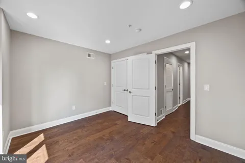a view of walk in closet with wooden floor