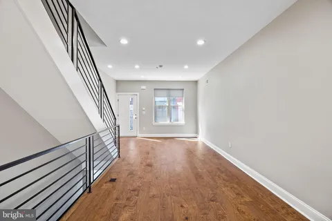 a view of kitchen with furniture and refrigerator