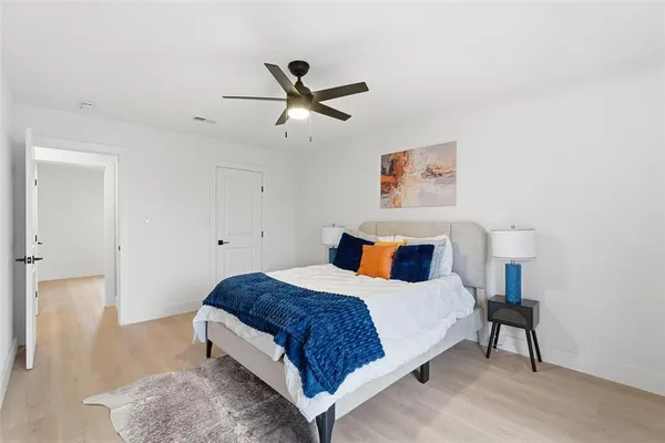 a bedroom with a bed and a painting on the wall