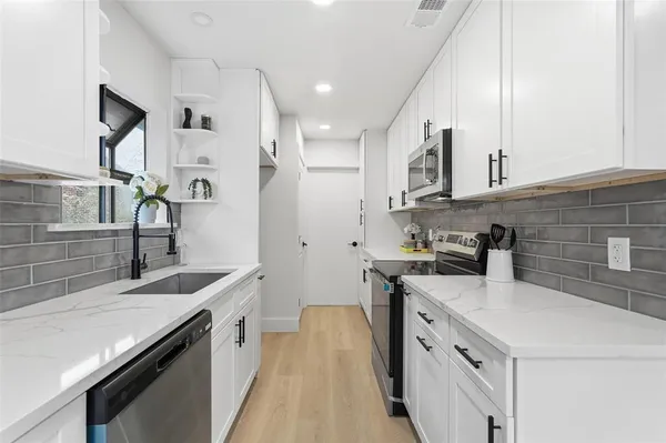 a kitchen with a sink stove and refrigerator