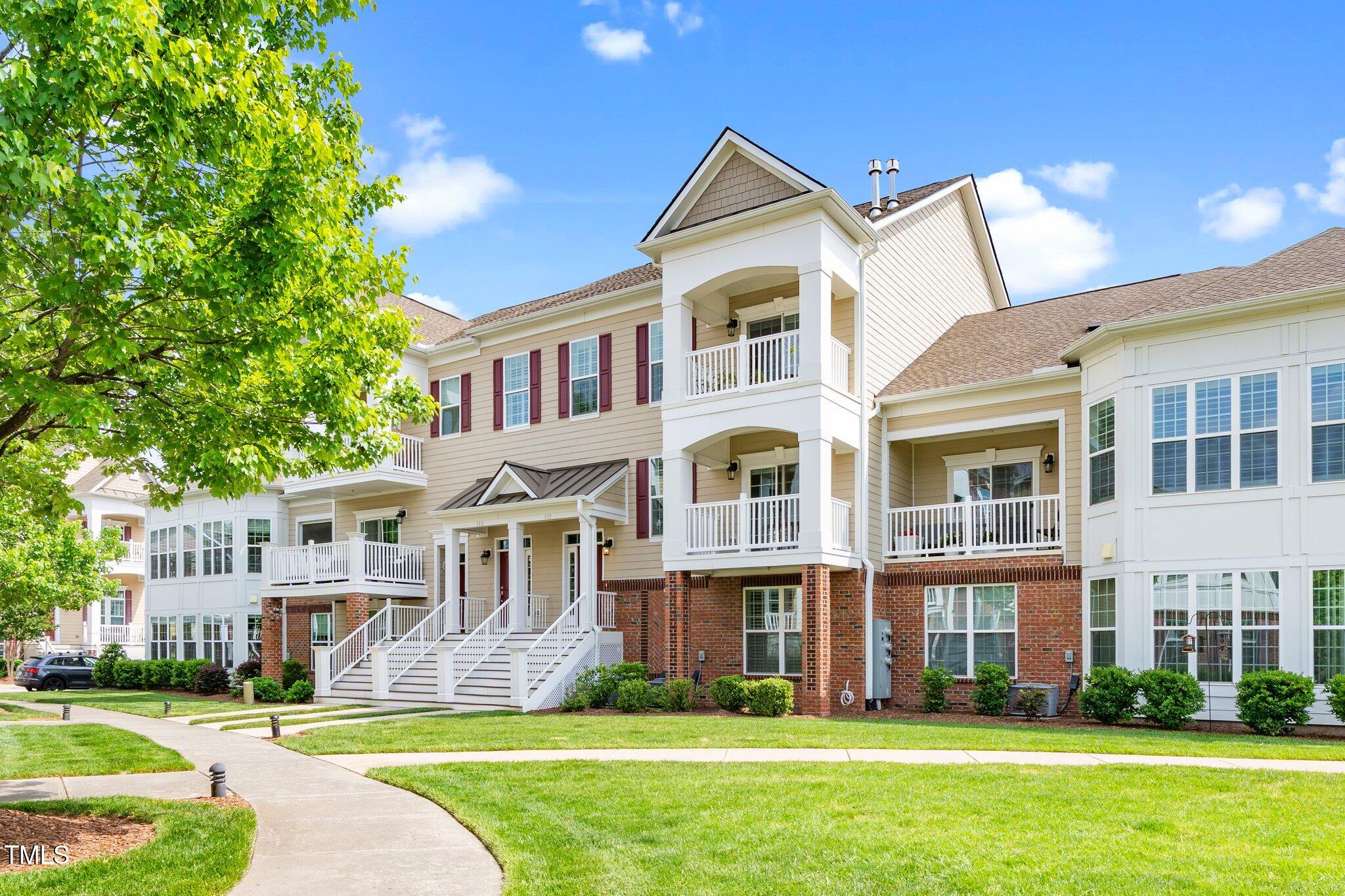 a front view of a building with a yard