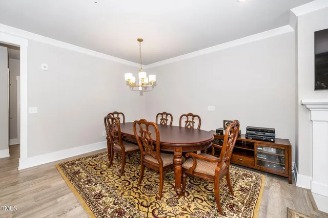 a dining room with furniture a rug and wooden floor