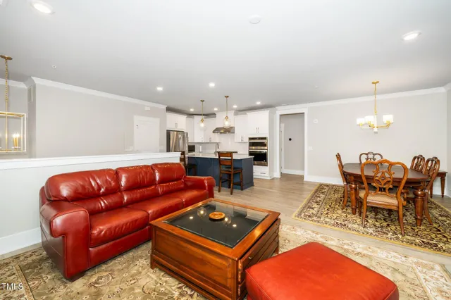 a living room with furniture a table and chairs