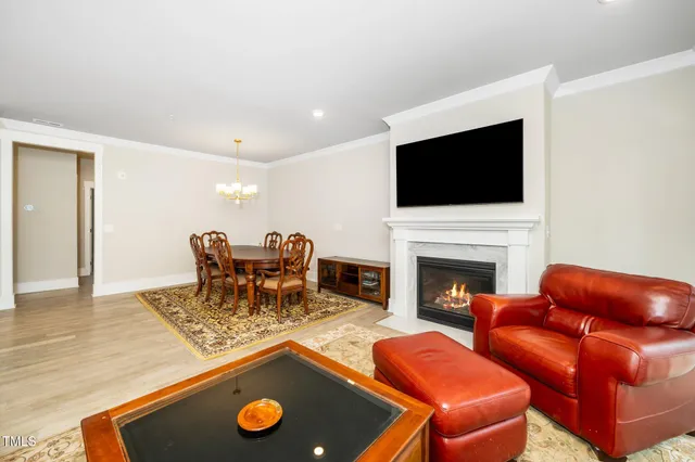 a living room with furniture fireplace and flat screen tv
