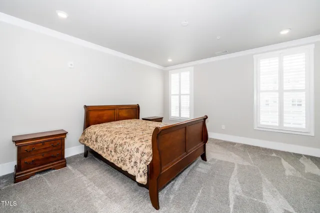 a bed sitting in a room next to a window