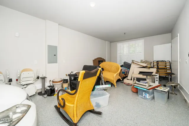 a living room with furniture gym equipment and a view of bedroom