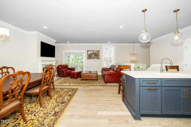 a living room with furniture a flat screen tv and kitchen view