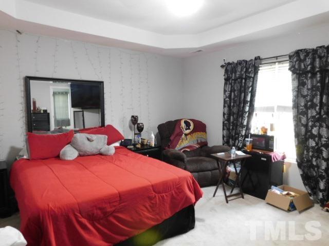 924 Roxy Street Raleigh, NC 27610 - Photo 12 of 15 a bedroom with a bed a couch and dresser