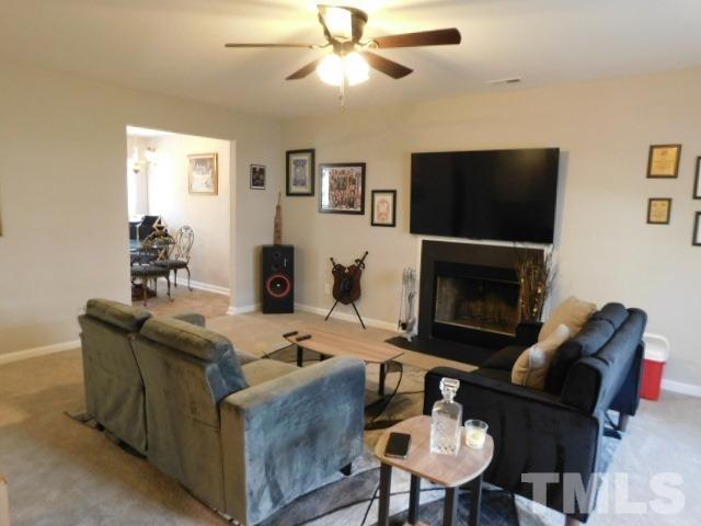924 Roxy Street Raleigh, NC 27610 - Photo 5 of 15 a living room with furniture a flat screen tv and a fireplace