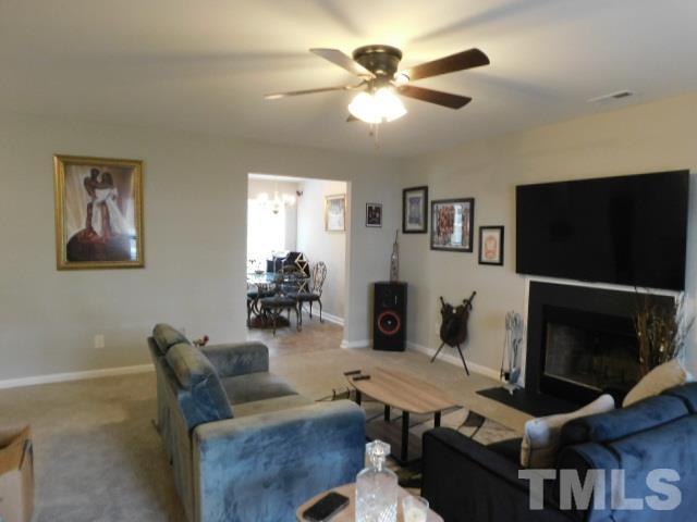 924 Roxy Street Raleigh, NC 27610 - Photo 6 of 15 a work room with furniture and a flat screen tv