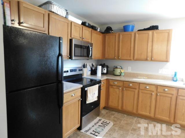 924 Roxy Street Raleigh, NC 27610 - Photo 8 of 15 a kitchen with stainless steel appliances granite countertop a refrigerator a stove a sink and a microwave