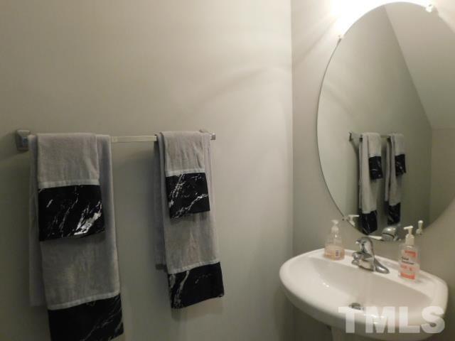 924 Roxy Street Raleigh, NC 27610 - Photo 10 of 15 a bathroom with a sink and a mirror