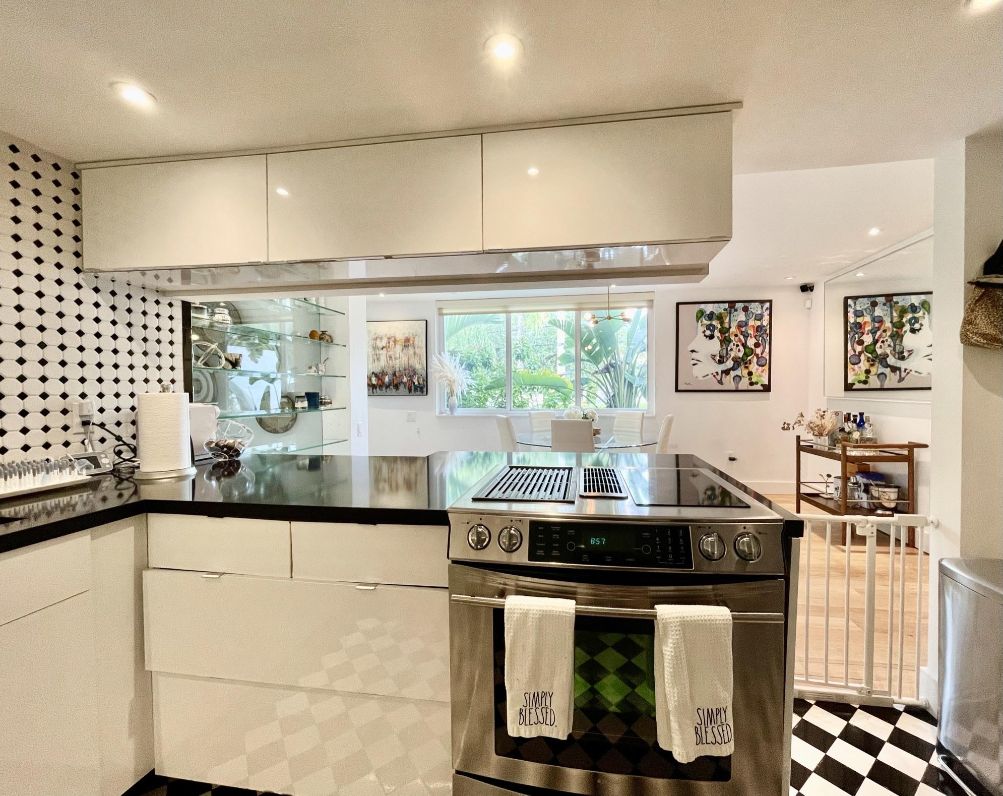 3258 Virginia Street, Unit A4 Miami, FL 33133 - Photo 11 of 20 a kitchen with stainless steel appliances kitchen island granite countertop a stove and a sink