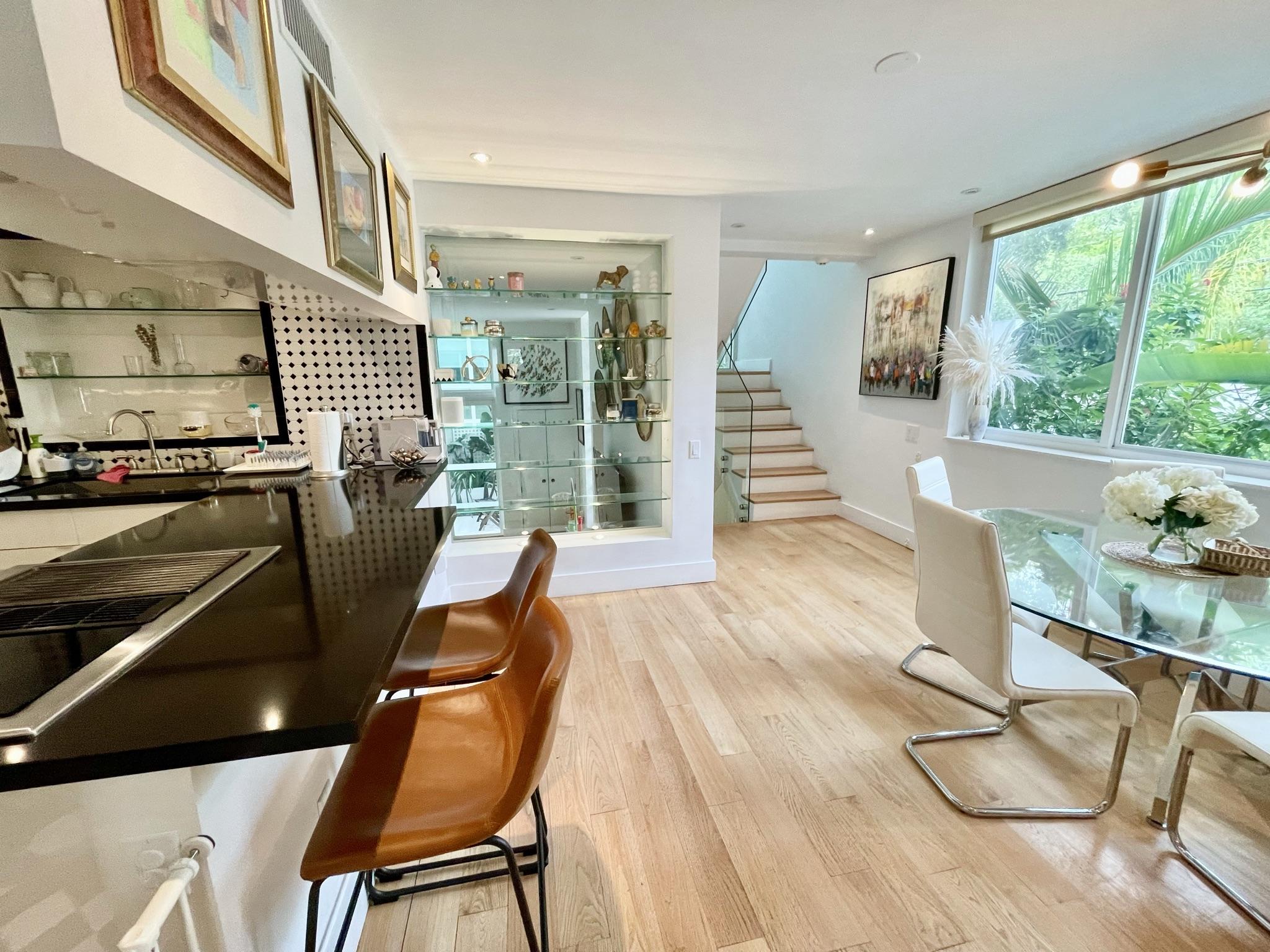 3258 Virginia Street, Unit A4 Miami, FL 33133 - Photo 8 of 20 a view of a dining room with furniture a chandelier and wooden floor