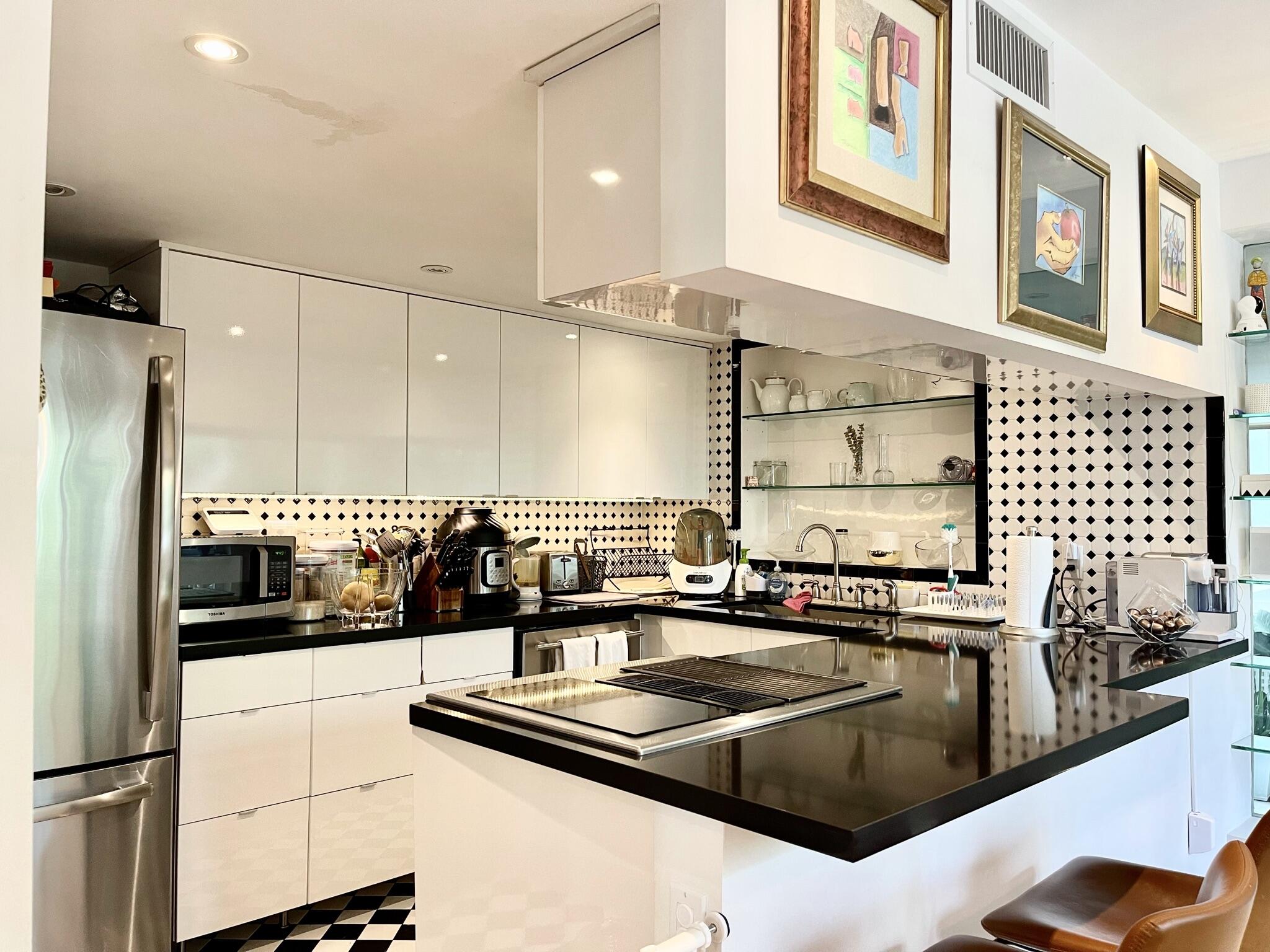 3258 Virginia Street, Unit A4 Miami, FL 33133 - Photo 10 of 20 a kitchen with stainless steel appliances a sink and a stove