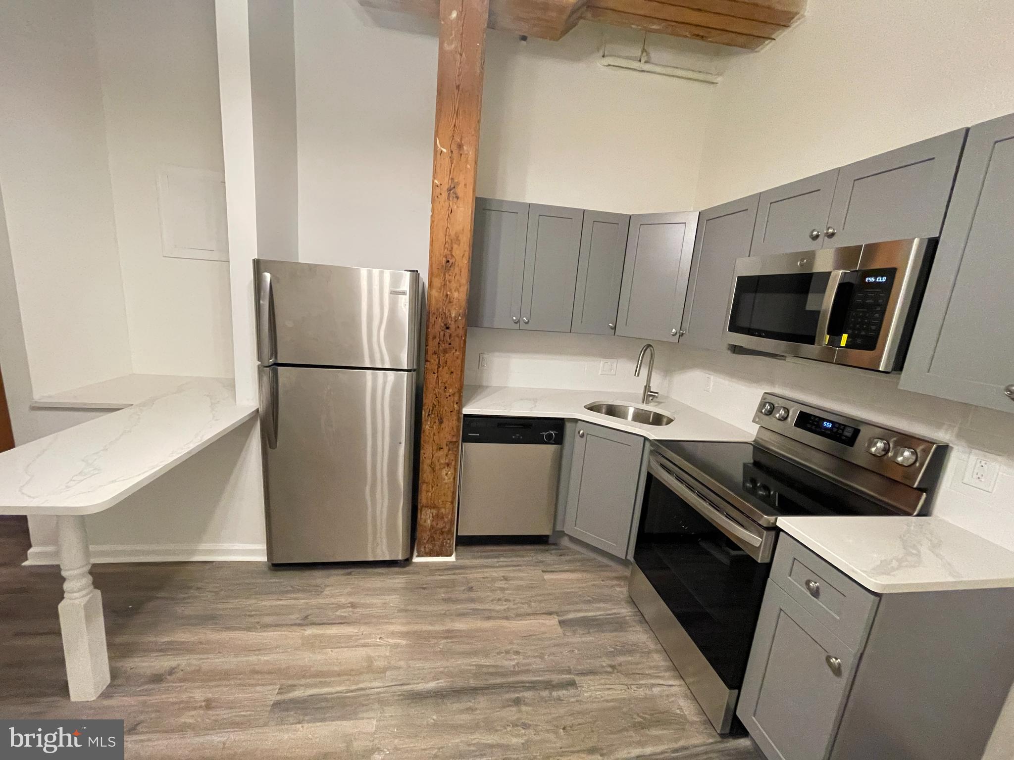 1020 Hamilton Street, Unit 4 Philadelphia, PA 19123 - Photo 10 of 19 a kitchen with a refrigerator stove and microwave
