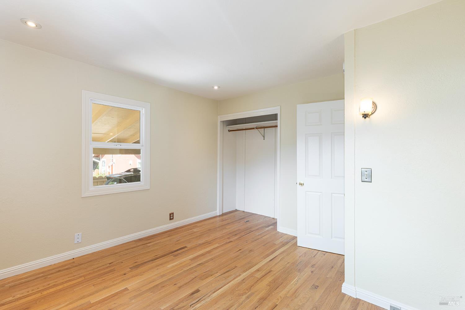 18090 Las Lomas Road Sonoma, CA 95476 - Photo 20 of 37 a view of empty room with wooden floor and fan