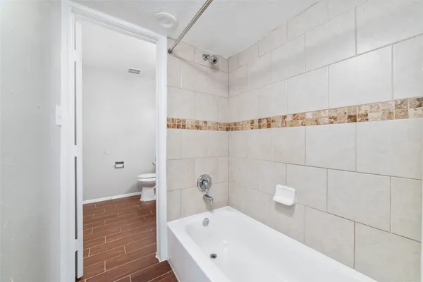 a bathroom with a bathtub and a shower