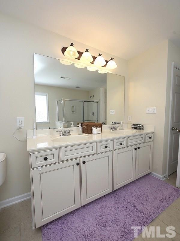 850 Seastone Street Raleigh, NC 27603 - Photo 14 of 25 a bathroom with a sink vanity and a mirror