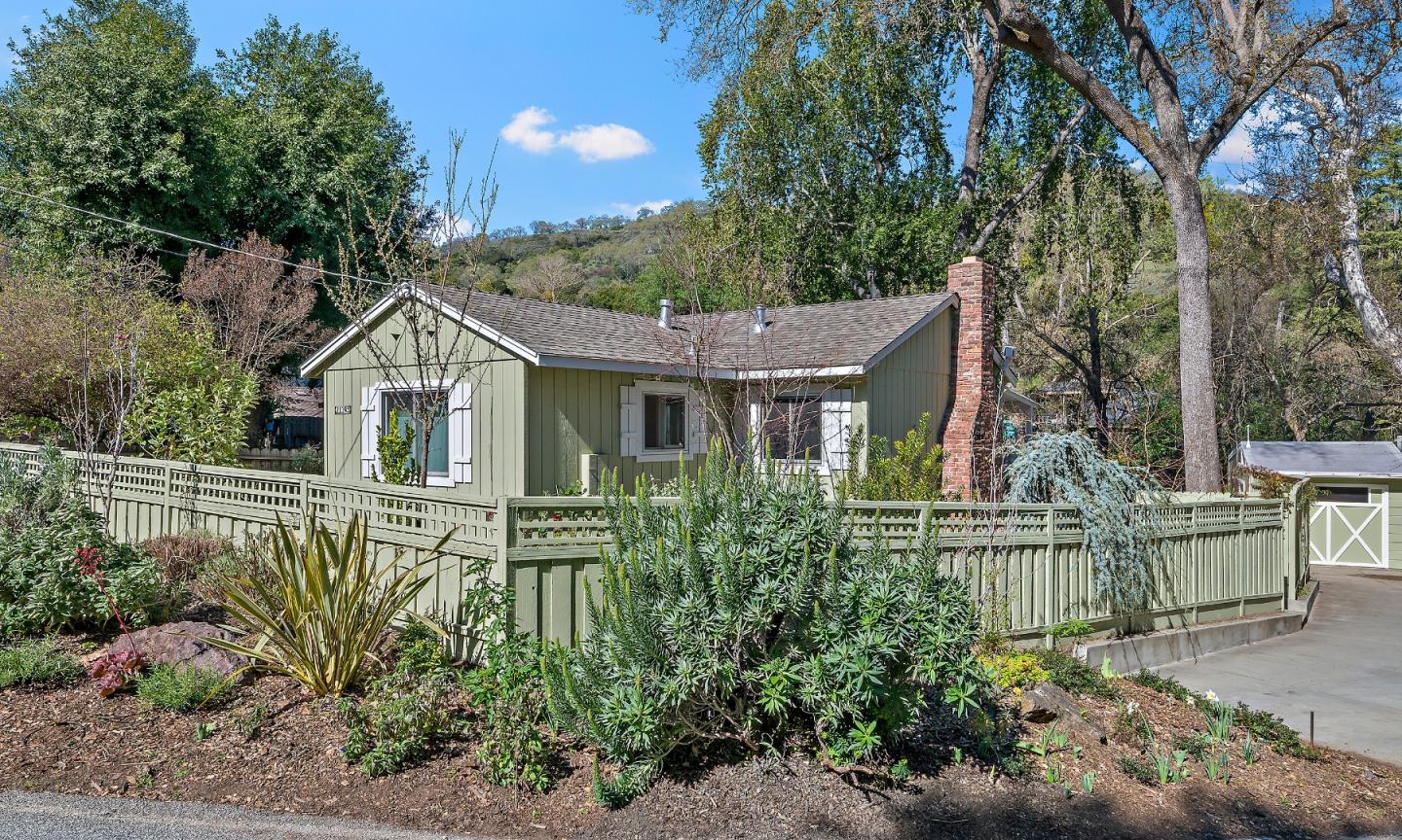 a front view of a house with a garden
