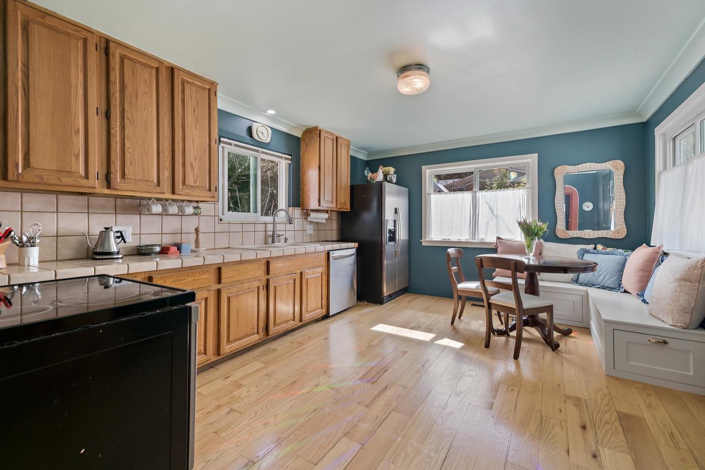 21195 Bertram Road San Jose, CA 95120 - Photo 4 of 20 a kitchen with a sink cabinets and wooden floor