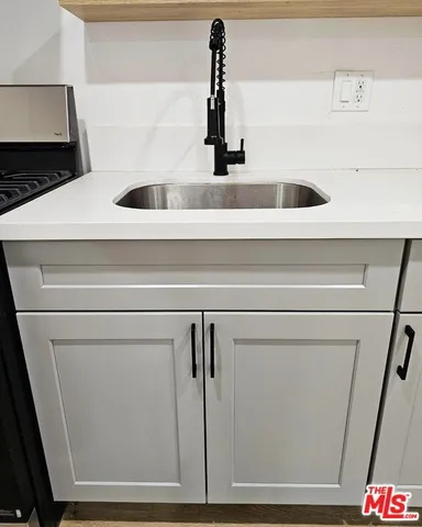 a kitchen with stainless steel appliances a refrigerator stove and sink